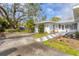 Long driveway of a single-story home featuring an attached garage and manicured front yard landscaping at 804 33Rd Street W Ct, Bradenton, FL 34205