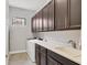 Well-equipped laundry room features modern appliances, ample cabinet space, and a sink at 8188 Gabanna Dr, Sarasota, FL 34231