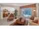 Bright living room featuring tile floors, a view of the pool, and comfortable seating at 8215 Waterview Blvd, Lakewood Ranch, FL 34202