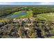 Beautiful aerial shot of a golf course featuring a large pond, manicured greens, and a clubhouse at 8455 Lindrick Ln, Bradenton, FL 34202