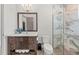 Bathroom featuring elegant vanity, shower with glass doors, and tile flooring at 8455 Lindrick Ln, Bradenton, FL 34202