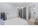 Bedroom with light blue walls, white dresser and views into bathroom and closet at 8455 Lindrick Ln, Bradenton, FL 34202
