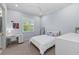 Bedroom featuring a white bed frame, desk, and serene light blue walls at 8455 Lindrick Ln, Bradenton, FL 34202