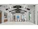 Stunning dining room featuring vaulted ceilings, exposed beams, and modern chandelier at 8455 Lindrick Ln, Bradenton, FL 34202