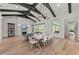 Open dining room featuring a large table, wooden floors, and decorative lighting with easy access to living spaces at 8455 Lindrick Ln, Bradenton, FL 34202