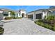 Stunning single-story home with a three car garage, paver driveway, and lush landscaping at 8455 Lindrick Ln, Bradenton, FL 34202
