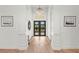 Bright foyer with chandelier and view to front entrance at 8455 Lindrick Ln, Bradenton, FL 34202