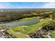 Expansive aerial shot of the golf course, with a serene lake and manicured greens, a luxurious community amenity at 8455 Lindrick Ln, Bradenton, FL 34202
