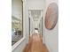 Hallway with hardwood flooring, natural light, and designer accents at 8455 Lindrick Ln, Bradenton, FL 34202