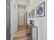 Hallway featuring shiplap walls, decorative console table and light wood floors at 8455 Lindrick Ln, Bradenton, FL 34202