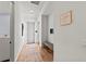 Hallway with wood floors, bench, and recessed lighting at 8455 Lindrick Ln, Bradenton, FL 34202