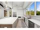 Modern kitchen features stainless steel appliances, custom cabinets, a large island and access to outdoor views at 8455 Lindrick Ln, Bradenton, FL 34202