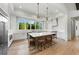 Bright kitchen offers a central island, white cabinetry, and a view to the adjacent dining room, ideal for modern living at 8455 Lindrick Ln, Bradenton, FL 34202