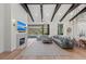 Spacious living room with fireplace, modern lighting, and view of screened pool area at 8455 Lindrick Ln, Bradenton, FL 34202