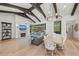 Bright living and dining area featuring modern lighting, fireplace, and direct pool access at 8455 Lindrick Ln, Bradenton, FL 34202