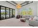 Bright living room with a decorative chandelier and sliding glass doors to the pool area at 8455 Lindrick Ln, Bradenton, FL 34202