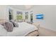 Bright main bedroom with a large window overlooking the backyard and a wall-mounted TV at 8455 Lindrick Ln, Bradenton, FL 34202