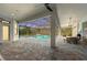 Covered screened-in pool area with outdoor kitchen, dining, and lounge area at 8455 Lindrick Ln, Bradenton, FL 34202