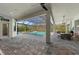 Screened in pool and patio with outdoor kitchen and dining area, offering seamless indoor/outdoor living and entertainment at 8455 Lindrick Ln, Bradenton, FL 34202