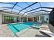 Resort-style screened pool with integrated spa and basketball hoop for outdoor fun at 8455 Lindrick Ln, Bradenton, FL 34202