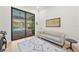 The room features a modern couch, rug, and large sliding glass doors leading to the pool area at 8455 Lindrick Ln, Bradenton, FL 34202