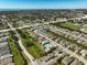 Wide aerial view of neighborhood featuring well-maintained homes, community pool and landscaping at 8928 Excelsior Loop, Venice, FL 34293