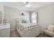 Bright bedroom with a full size bed with floral bedding and a large window offering ample natural light at 8928 Excelsior Loop, Venice, FL 34293