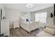 Bright bedroom with a starfish themed bedspread, wood floors, and a charming beach-themed painting at 8928 Excelsior Loop, Venice, FL 34293