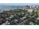 Aerial view of a waterfront neighborhood with canals, multiple boat slips, and a cityscape in the background at 980 S Orange Ave, Sarasota, FL 34236