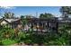 Enclosed pool and spa area with a deck for entertaining, surrounded by lush landscaping at 980 S Orange Ave, Sarasota, FL 34236