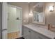 Bathroom features a sleek vanity with marble countertops, complemented by a large mirror at 980 S Orange Ave, Sarasota, FL 34236