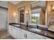 Bright bathroom with double vanity featuring elegant mirrors and wallpaper at 980 S Orange Ave, Sarasota, FL 34236