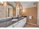 Bright bathroom with double vanity featuring elegant mirrors and wallpaper at 980 S Orange Ave, Sarasota, FL 34236