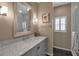 Elegant bathroom featuring marble countertop, a large mirror, and a stylish shower with white tile at 980 S Orange Ave, Sarasota, FL 34236