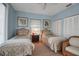 Comfortable bedroom featuring twin beds, ceiling fan, and hardwood floors at 980 S Orange Ave, Sarasota, FL 34236