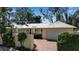 Charming single-story home with well-manicured landscaping and a brick driveway at 980 S Orange Ave, Sarasota, FL 34236