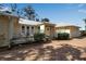Charming exterior with a brick driveway, white fencing, and lush landscaping at 980 S Orange Ave, Sarasota, FL 34236