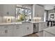 Bright kitchen features white cabinets, stone countertops, stainless steel appliances, and plenty of natural light at 980 S Orange Ave, Sarasota, FL 34236