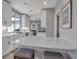 Bright, open kitchen featuring white cabinetry, stone countertops, modern appliances, and breakfast bar seating at 980 S Orange Ave, Sarasota, FL 34236