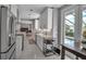 Bright white kitchen with stainless steel appliances and convenient wine rack next to door to the pool at 980 S Orange Ave, Sarasota, FL 34236