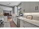 Bright, modern kitchen featuring white cabinets, stone countertops, stainless steel appliances, and open layout at 980 S Orange Ave, Sarasota, FL 34236