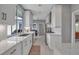 Bright kitchen featuring white cabinets, modern appliances, stone countertops, and a view of the outdoors at 980 S Orange Ave, Sarasota, FL 34236