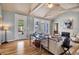 Bright living room with vaulted ceilings, fireplace, and access to the outdoors at 980 S Orange Ave, Sarasota, FL 34236