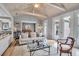 Comfortable living room with vaulted ceilings, wooden floors and connecting dining room at 980 S Orange Ave, Sarasota, FL 34236
