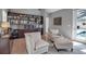 Cozy sitting area with built-in shelves, comfortable chairs, and a view of the pool through large windows at 980 S Orange Ave, Sarasota, FL 34236