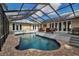 Backyard features a beautiful screened-in pool area with a deck, outdoor furniture, and direct access to the house at 980 S Orange Ave, Sarasota, FL 34236