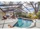 Beautiful, screened-in pool with deck and plenty of seating for outdoor relaxation and enjoyment of tropical landscaping at 980 S Orange Ave, Sarasota, FL 34236