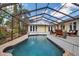 Inviting screened-in pool with deck and comfortable seating, perfect for relaxing and enjoying the outdoor space at 980 S Orange Ave, Sarasota, FL 34236