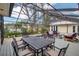 Stylish screened-in pool area with a deck and dining table, creating an ideal setting for outdoor gatherings and entertaining at 980 S Orange Ave, Sarasota, FL 34236