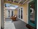 Charming porch with wicker chairs and a view of the surrounding landscaping at 980 S Orange Ave, Sarasota, FL 34236